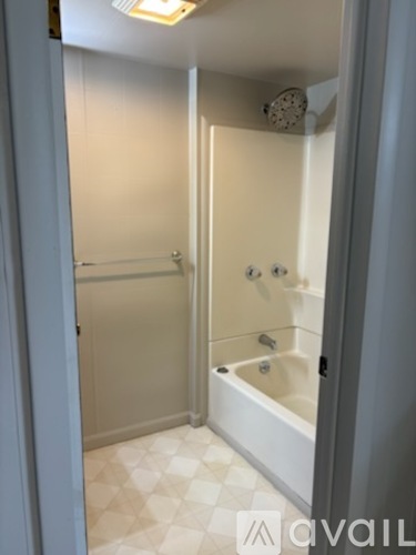 A white bathroom with a tub and shower.