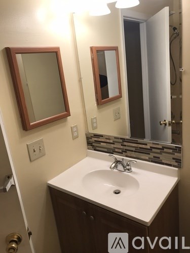 A bathroom with a sink and mirrors.