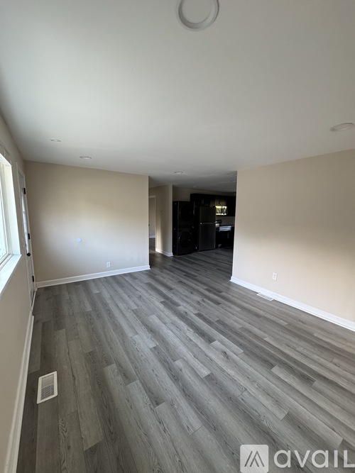 A room with wooden flooring and a white ceiling.