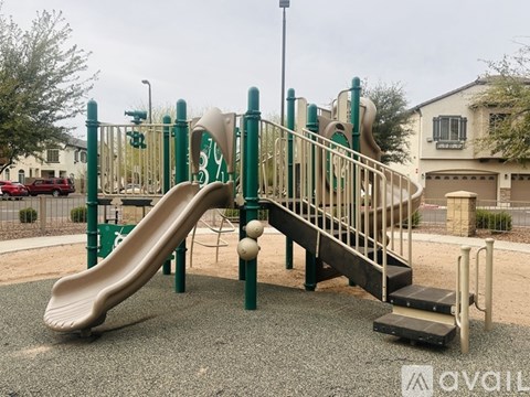 A playground with a green slide and a yellow slide.
