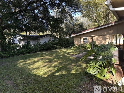 A backyard with a lawn and trees.
