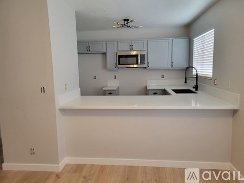 A kitchen with white cabinets and a countertop.