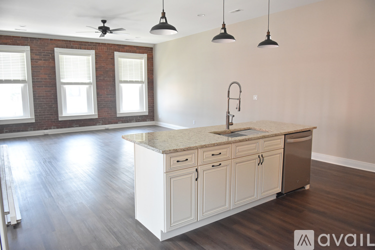 A kitchen with a white countertop and cabinets is available for rent.