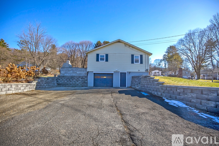A house with a driveway in front of it is for sale.
