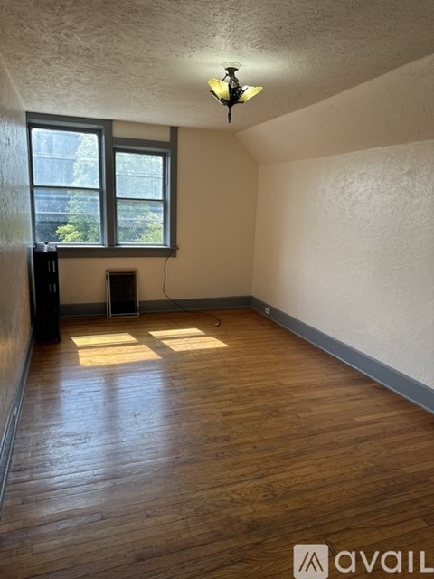 A room with wooden floors and a window.
