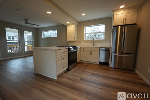 A kitchen with wooden floors and stainless steel appliances.
