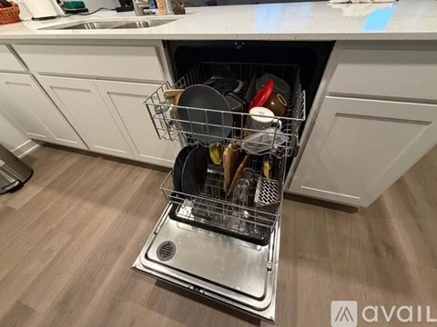 A dishwasher with a full rack of dishes.