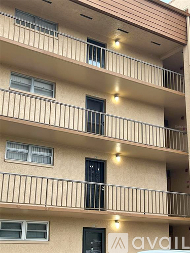 A building with the word "avall" on the balcony.