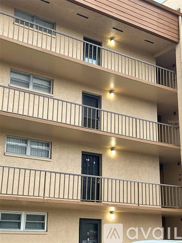 A building with the word "avall" on the balcony.