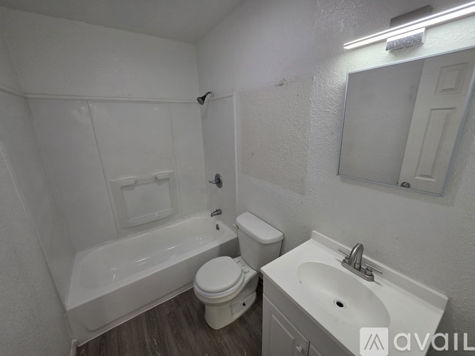 A bathroom with a toilet, sink, and bathtub.
