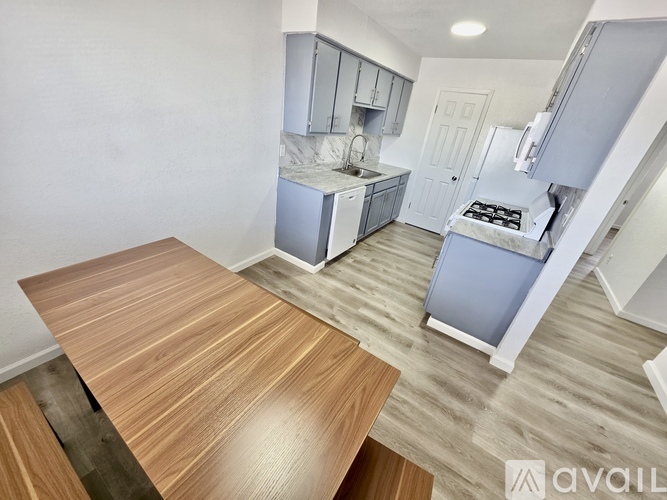 A kitchen with a wooden table and a stove top oven.