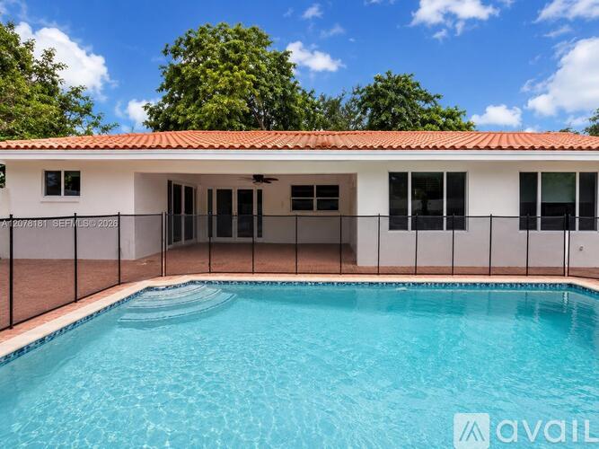 A pool in front of a house with a sign that says "available".