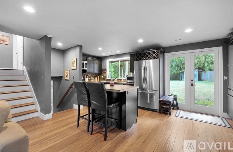 A modern kitchen with a dining table and chairs.
