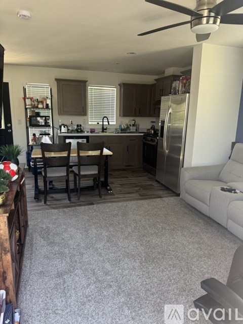 A kitchen with a dining table and chairs.