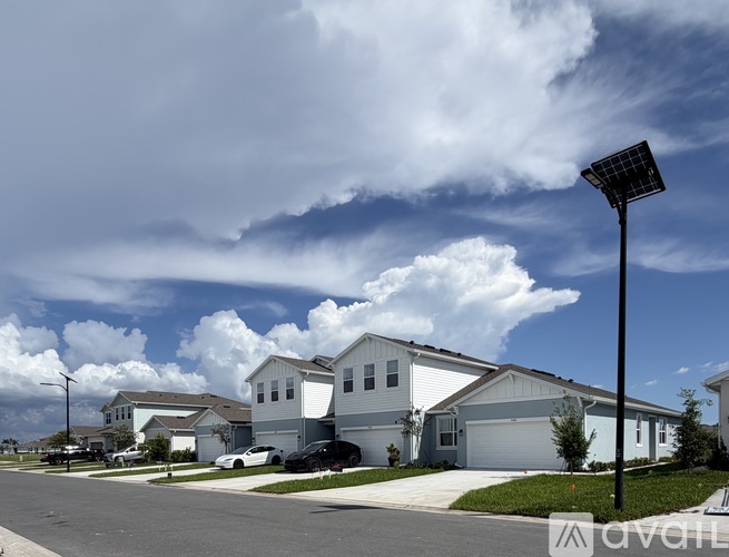 A row of houses with a street lamp in the foreground.