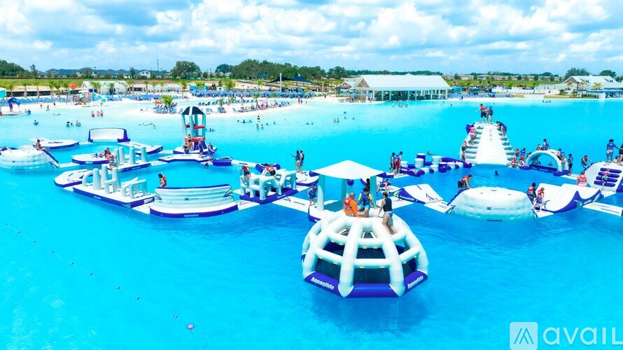 A large pool with a water slide and a water play area.