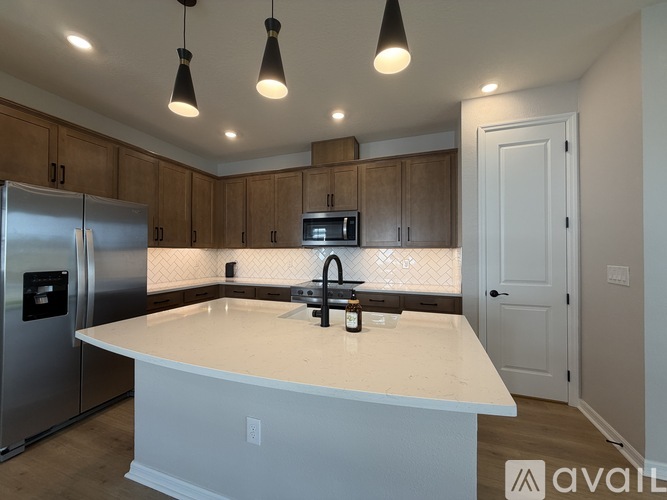 A kitchen with a white countertop and a refrigerator.
