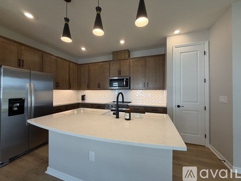 A kitchen with a white countertop and a refrigerator.