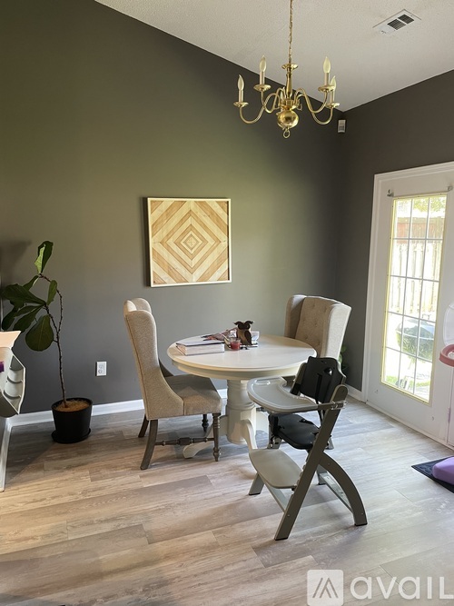 A dining room with a white table and chairs.