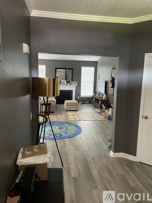 A room with a grey wall and a white door.