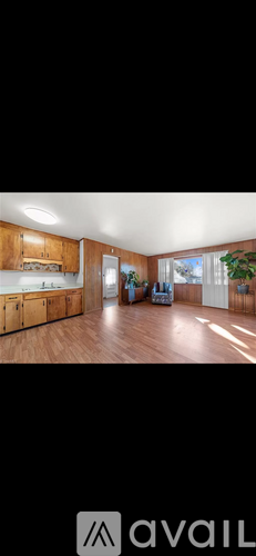 A modern kitchen with wooden cabinets and a large island.