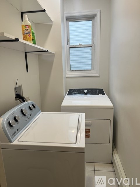 A small laundry room with a washer and dryer.