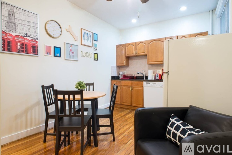A kitchen with a table and chairs in front of it.