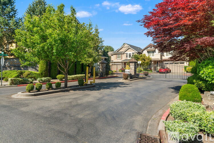 A residential street with houses and trees.