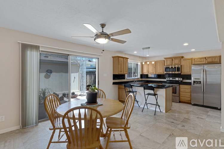 A kitchen with a table and chairs in the middle of the room.