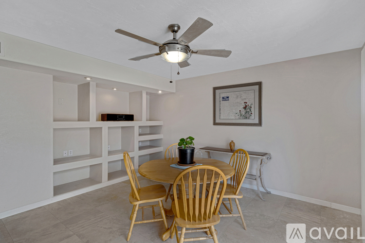 A dining room with a table set for four.