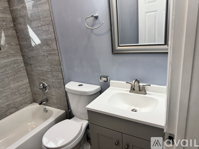 A bathroom with a toilet, sink, and bathtub.