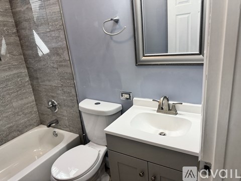 A bathroom with a toilet, sink, and bathtub.