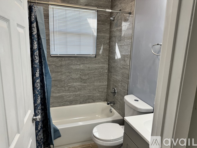 A bathroom with a toilet, sink, and bathtub.