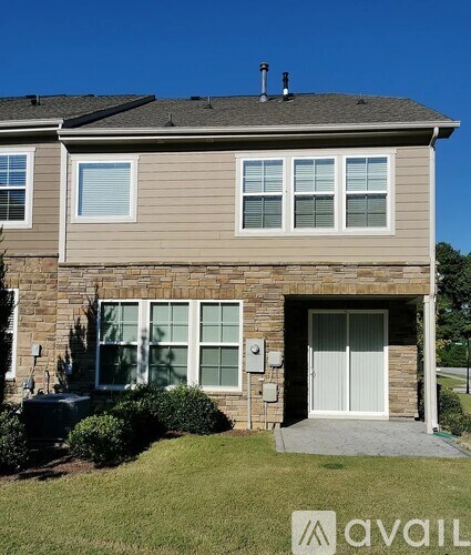 A house with a grey roof and a white door.