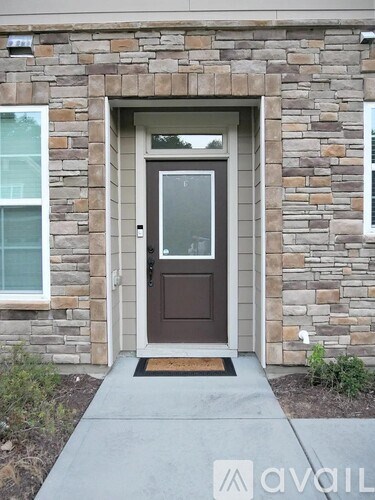 A brown door is on a stone building.