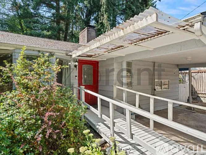 A house with a red door and a white porch.