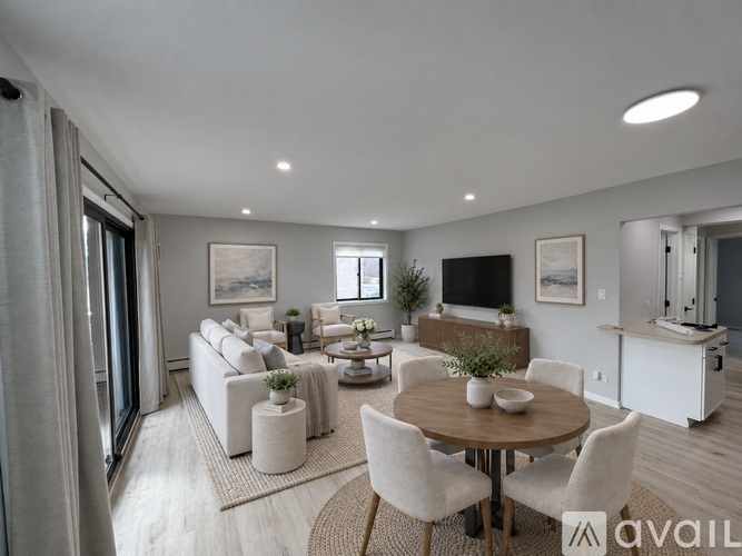 A modern living room with a dining table and chairs.