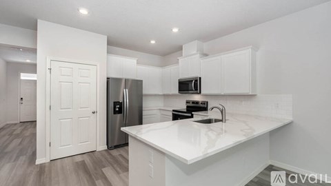 A modern kitchen with white cabinets and a central island.