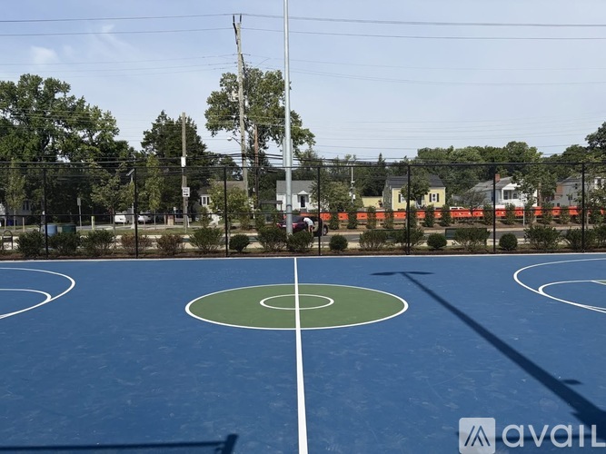 A basketball court with a green circle in the middle.
