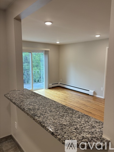 A room with a granite countertop and a window.