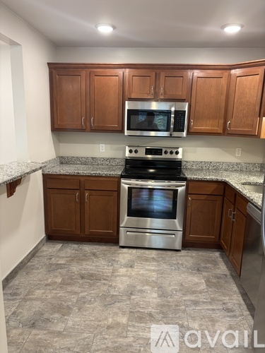 A kitchen with a stove top oven and microwave above it.