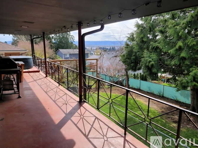 A balcony with a metal railing and a view of the outdoors.
