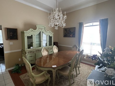 A dining room with a wooden table and chairs.