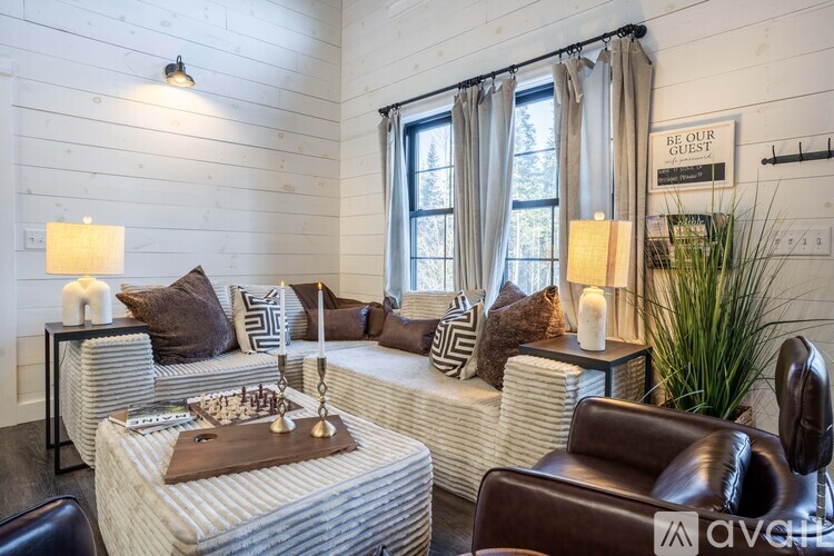 A living room with a sofa, armchair, and a coffee table.