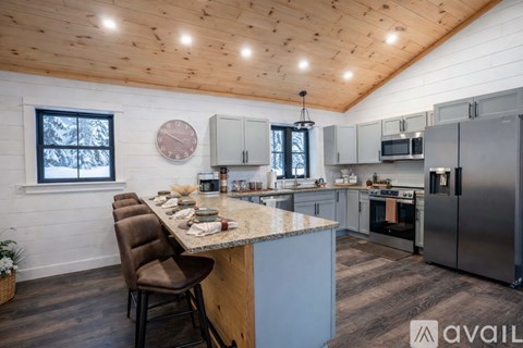 A kitchen with a brown chair and a marble countertop.