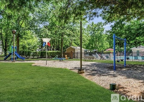 A playground with a blue swing set and a yellow slide.