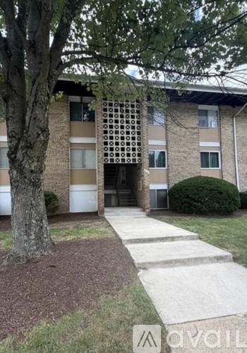 A building with a tree in front of it.