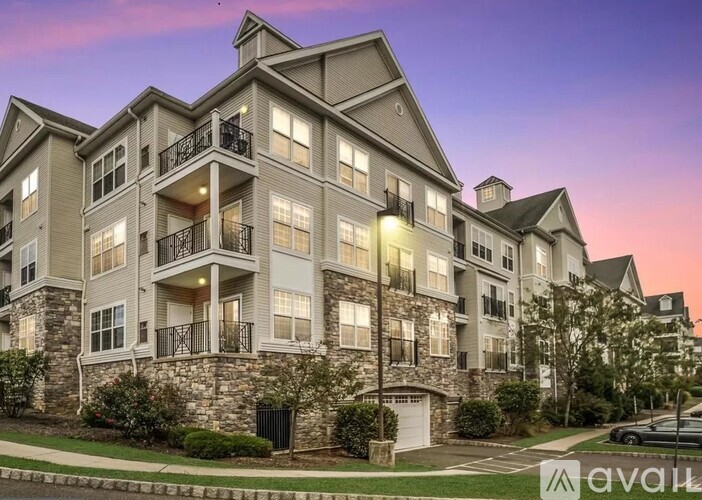 A large apartment building with multiple balconies and a stone facade.