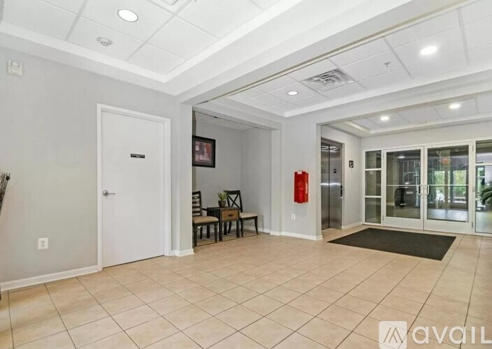 A spacious room with a fire extinguisher on the wall.