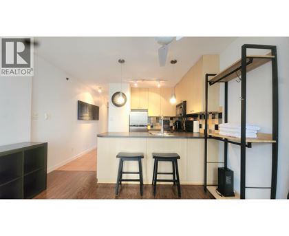 A kitchen with a bar stool and a counter.